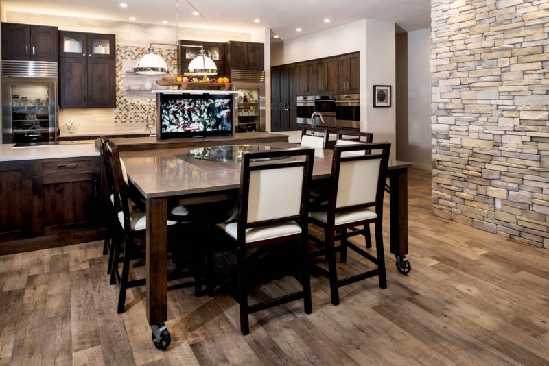 Heart of the Treehouse 1 modern kitchen featuring roll away table and pop up television in the island