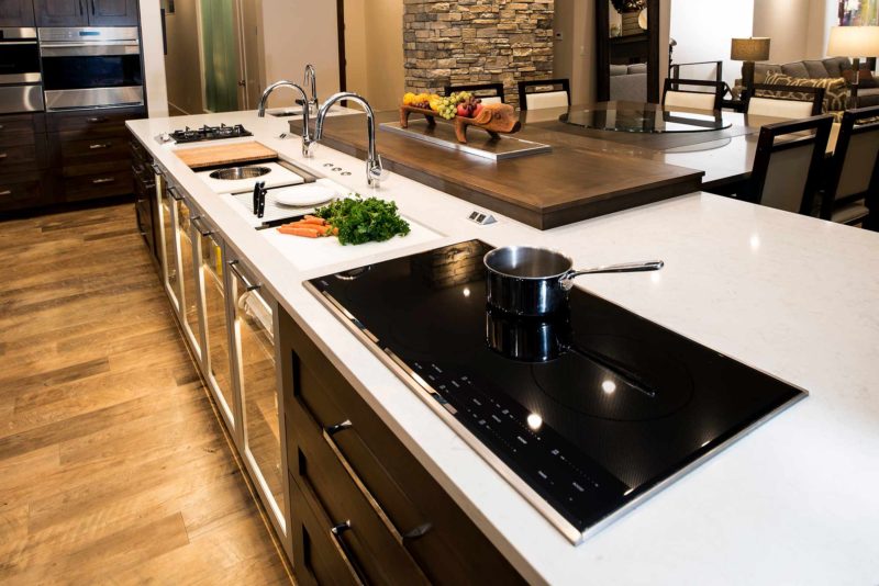 Heart of the Treehouse 4 modern kitchen with Galley Workstation large kitchen sink and induction cooking on the island